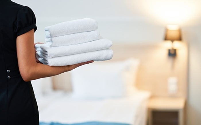 Picture Of Maid With Fresh Towels In Hotel Room